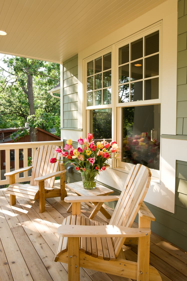 Chairs and flowers on home front porch.